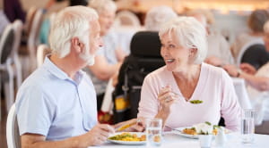 Retirement planning tips senior couple smiling having dinner
